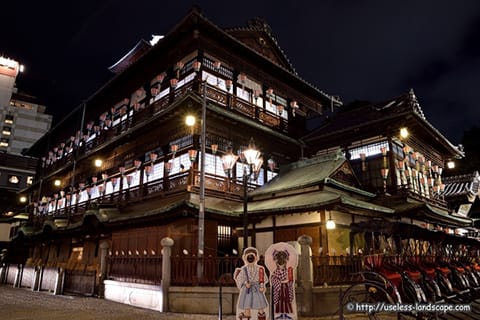 Dogo Onsen Honkan lit up at night