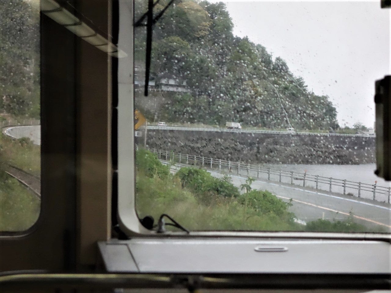 Coastal Yosan line local train running along the Iyonada shore